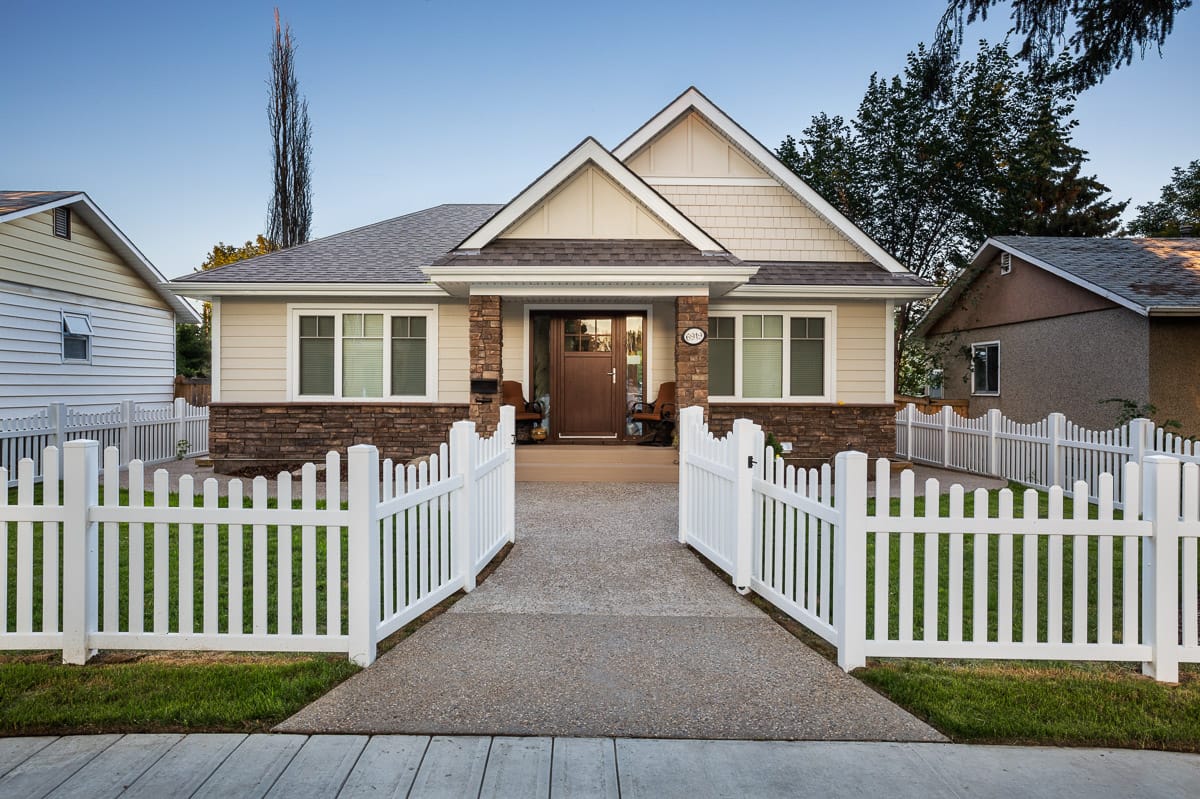 Michael Homes custom bungalow with a front porch and white fence