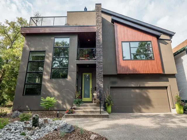 Modern infill custom home with stucco, cedar-tone panel and stacked stone