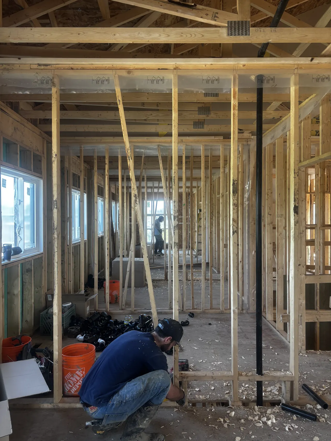 Framer at work inside a wood-framed suite